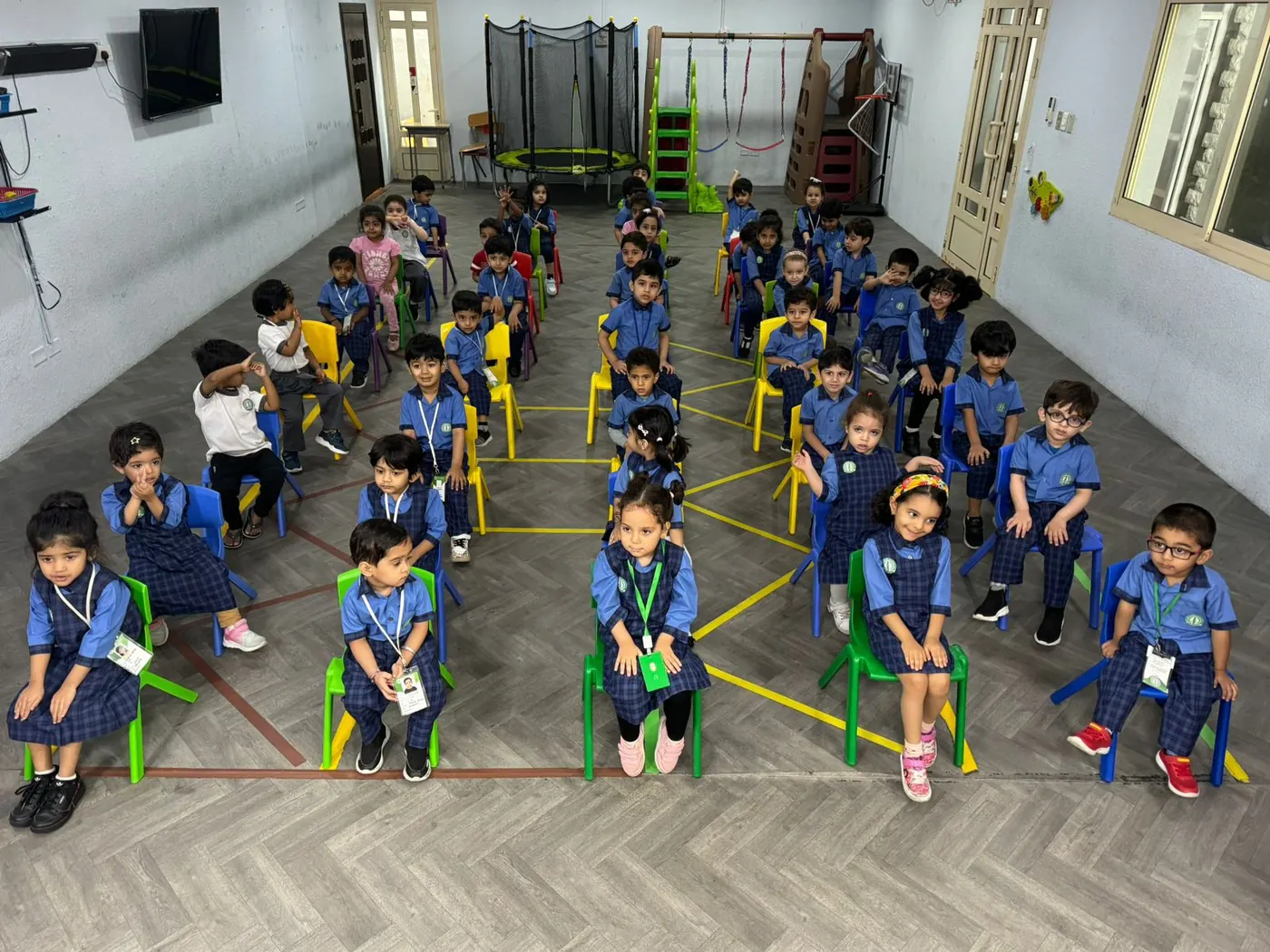 Children gathered together in the King Fahd Centre indoor gym